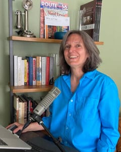 Karen sitting at desk with microphone and computer
